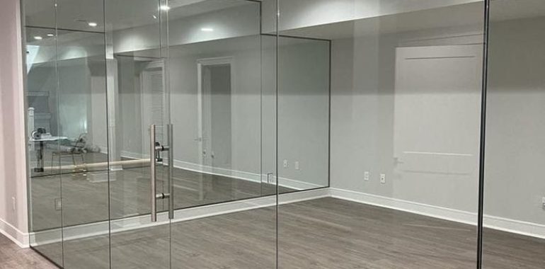 framed glass partition with door-space efficient design